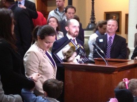 Aaron Klepinger clutching a photo of his son Hunter.